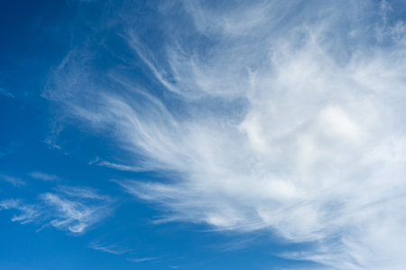 Soft white cirrus clouds against the blue sky on a sunny day. Empty space use for background or backdrop in nature conceptの写真素材