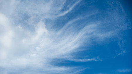 Soft white cirrus clouds against the blue sky on a sunny day. Empty space use for background or backdrop in nature conceptの写真素材