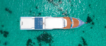 Aerial view of scuba diving boat or recreational vessel anchoring over turquoise clear water at Racha Island or Koh Racha, A popular destination for summer vacationの写真素材