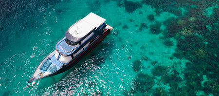 Aerial view of recreational vessel or scuba diving boat anchoring together over turquoise clear water at Racha Island or Koh Racha, A popular destination for summer vacation in Phuket, Thailand.の写真素材
