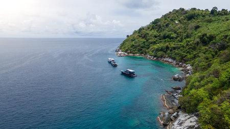 Group of recreational vessels or scuba diving boats anchoring over turquoise clear water at Racha Noi Island or Koh Racha Noi in Phuket, Thailand. Aerial view of a popular destination in Andaman seaの写真素材