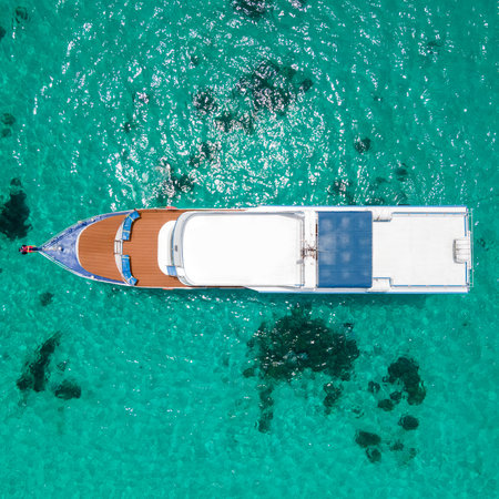 Aerial view of scuba diving boat or recreational vessel anchoring over turquoise clear water at Racha Island or Koh Racha, A popular destination for summer vacationの写真素材