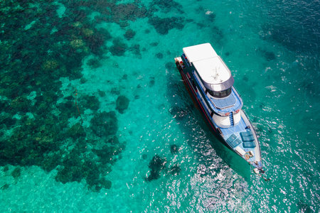 Aerial view of recreational vessel or scuba diving boat anchoring together over turquoise clear water at Racha Island or Koh Racha, A popular destination for summer vacation in Phuket, Thailand.の写真素材