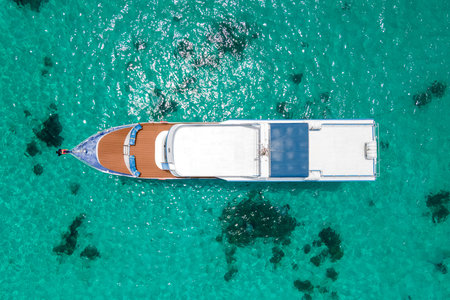 Aerial view of scuba diving boat or recreational vessel anchoring over turquoise clear water at Racha Island or Koh Racha, A popular destination for summer vacationの写真素材