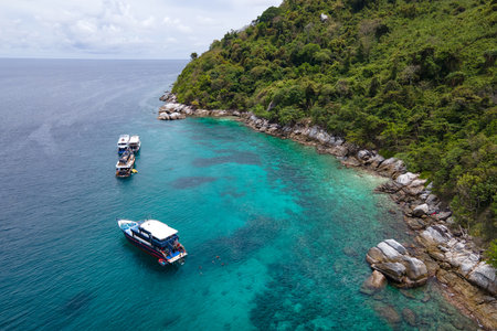 Group of recreational vessels or scuba diving boats anchoring over turquoise clear water at Racha Noi Island or Koh Racha Noi in Phuket, Thailand. Aerial view of a popular destination in Andaman seaの写真素材