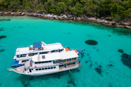 Aerial view of two recreational vessels or scuba diving boat anchoring together over turquoise clear water at Racha Island or Koh Racha, A popular destination for summer vacation in Phuket, Thailand.の写真素材