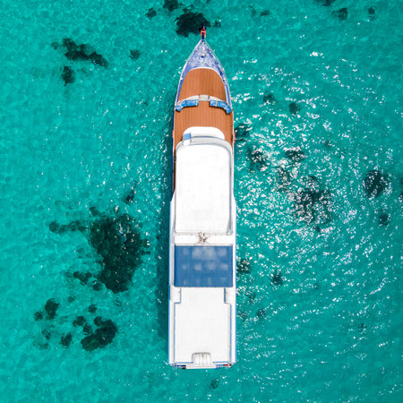 Aerial view of scuba diving boat or recreational vessel anchoring over turquoise clear water at Racha Island or Koh Racha, A popular destination for summer vacationの写真素材