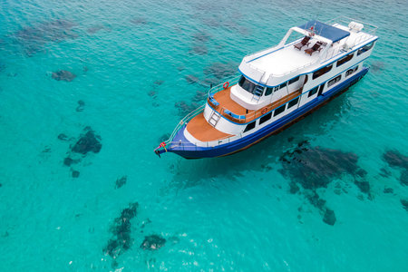 Aerial view of recreational vessel or scuba diving boat anchoring over turquoise clear water at Racha Island or Koh Racha, A popular destination for summer vacation in Phuket, Thailand.の写真素材