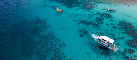 Aerial view of tourboat and longtail boat anchoring at Koh Racha Yai Island. A popular destination for summer vacation activityの写真素材