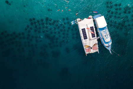 Aerial view of tour boat and catamaran anchoring over the artificial reef at Racha Yai Island or Koh Raya. A popular destination for summer activityの写真素材