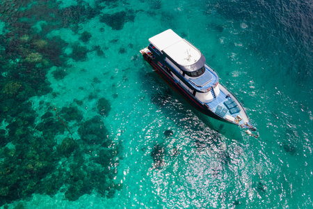 Aerial view of recreational vessel or scuba diving boat anchoring together over turquoise clear water at Racha Island or Koh Racha, A popular destination for summer vacation in Phuket, Thailand.の写真素材