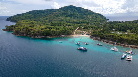 Aerial view of Koh Racha Yai Island with many tour boats, yacht, catamaran and longtail boat anchoring around the bay. A popular destination for summer vacationの写真素材