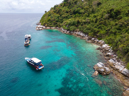 Group of recreational vessels or scuba diving boats anchoring over turquoise clear water at Racha Noi Island or Koh Racha Noi in Phuket, Thailand. Aerial view of a popular destination in Andaman seaの写真素材