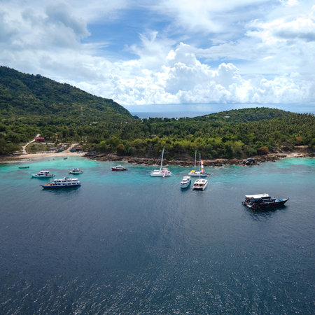 Aerial view of Koh Racha Yai Island with many tour boats, yacht, catamaran and longtail boat anchoring around the bay. A popular destination for summer vacationの写真素材