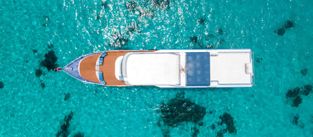Aerial view of scuba diving boat or recreational vessel anchoring over turquoise clear water at Racha Island or Koh Racha, A popular destination for summer vacationの写真素材
