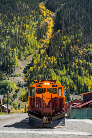 Durango and Silverton narrow gauge steam engine train stop in front of a beautiful mountain view...