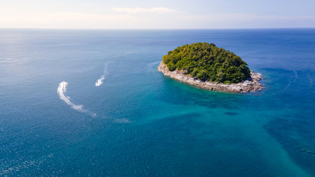 Aerial seascape of Ko Pu island or Koh Pu with speed boat speeding around, a small tropical island in Andaman sea near Kata Beach in Phuket Thailand. Summer vacation conceptの写真素材