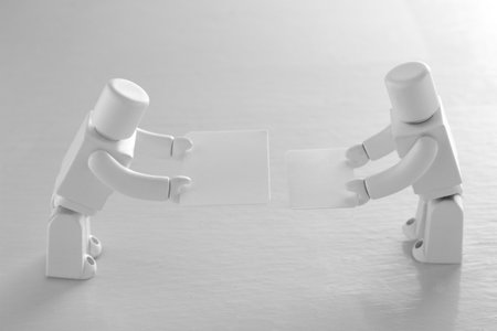 AI robots exchanging business cards in the business field of the future societyの写真素材