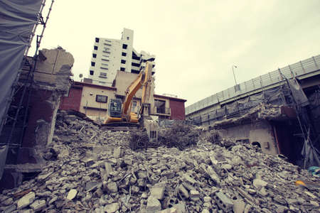 Demolition site for rebuilding city buildings using shovel carsの写真素材