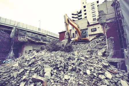 Demolition site for rebuilding city buildings using shovel carsの写真素材