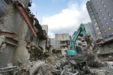 Demolition site for rebuilding city buildings using shovel carsの写真素材