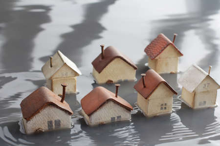 Homes submerged by river flooding and isolated peopleの写真素材
