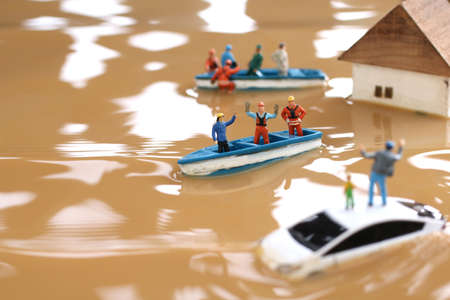 Diorama of rescuers heading to rescue by boat with people unable to evacuate because of flood damageの写真素材