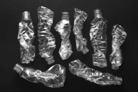 Crushed plastic bottle in black background