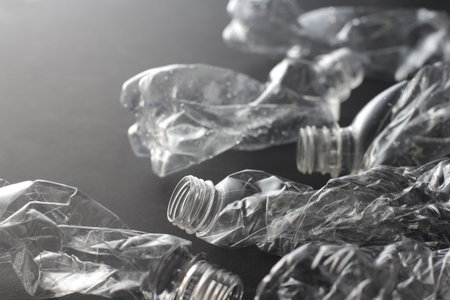 Crushed plastic bottle in black background