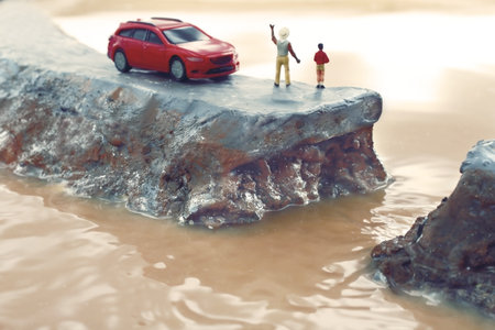 Diorama of levee breach due to heavy rain and people calling for helpの写真素材