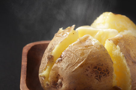 Steaming potatoes with butter on themの写真素材