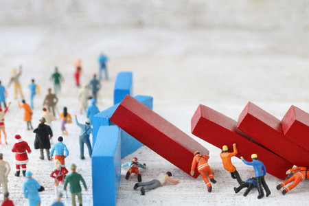 Diorama landscape representing crisis and safety using miniature dolls and dominoesの写真素材