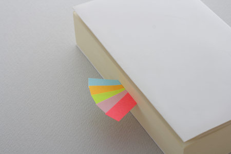 Colorful sticky notes sandwiched between books and materials