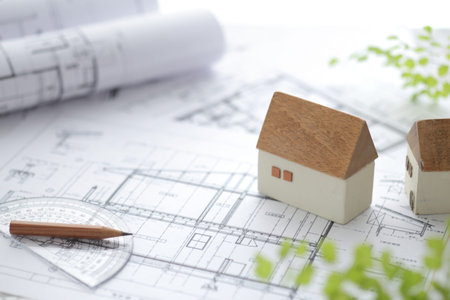 Image of a model of a house made of wood and a blueprint of my home