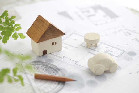 Image of a model of a house made of wood and a blueprint of my homeの写真素材