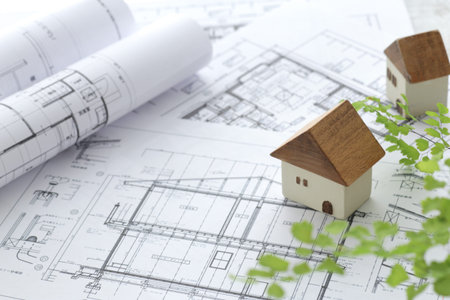 Image of a model of a house made of wood and a blueprint of my home