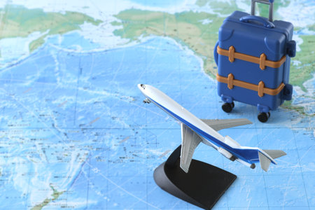 Model of an airplane departing for an international trip and a map of the worldの写真素材