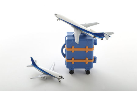 Suitcase and model airplane going on a trip