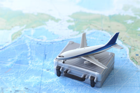 Model of an airplane departing for an international trip and a map of the worldの写真素材