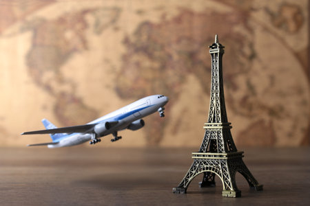 Image of overseas travel using a world map, an airplane and a model of the Eiffel Towerの写真素材