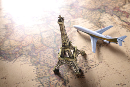 Image of overseas travel using a world map, an airplane and a model of the Eiffel Towerの写真素材