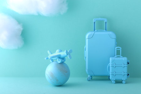 Image of an international trip on a blue background with model of an airplane, suitcase and cloudsの写真素材