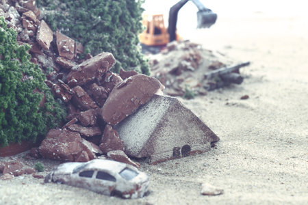 Diorama model of a house collapsed due to a disaster and the cityの写真素材