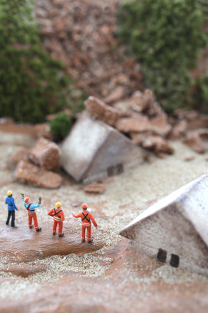 Diorama model of a house collapsed due to a disaster and the cityの写真素材