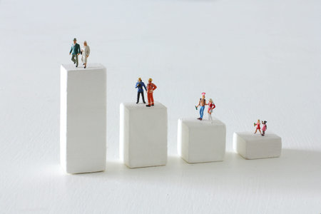 Miniature doll climbing the stairs of blocks and life planningの写真素材