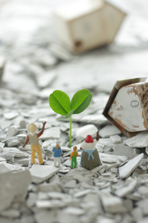 People pinning their hopes in the rubble of the city destroyed by the disaster and the regenerated greenery and flowersの写真素材