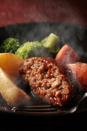 Juicy and delicious looking hamburger steak served on a plateの写真素材