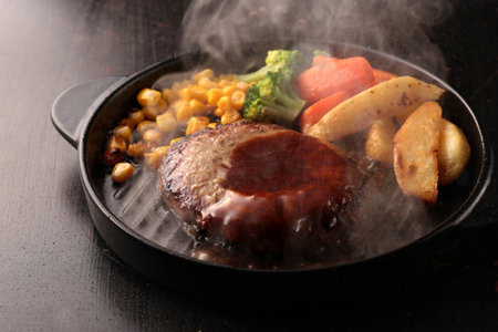 Juicy and delicious looking hamburger steak served on a plateの写真素材