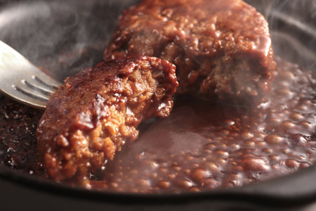 Juicy and delicious looking hamburger steak served on a plateの写真素材