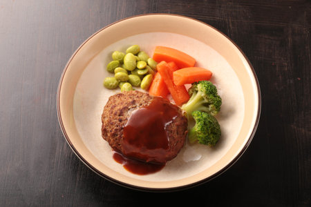 Juicy and delicious looking hamburger steak served on a plate or grilled on a hot plate